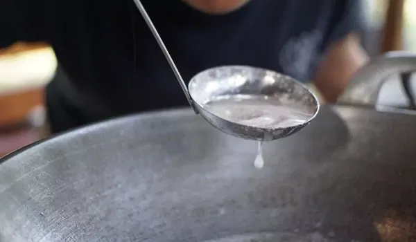 blowing the coconut oil to separate from water