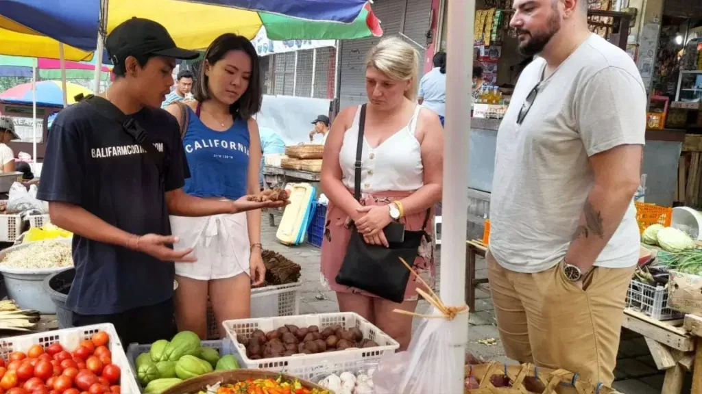 Our expert chef explaining spices at the market during the Morning Bali Cooking Class in Ubud.
