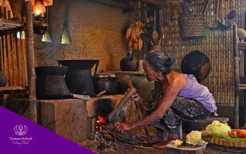 Interior of a traditional Balinese kitchen (Paon), the sacred heart of a Balinese home, showing its unique structure and connection to Dewa Brahma.