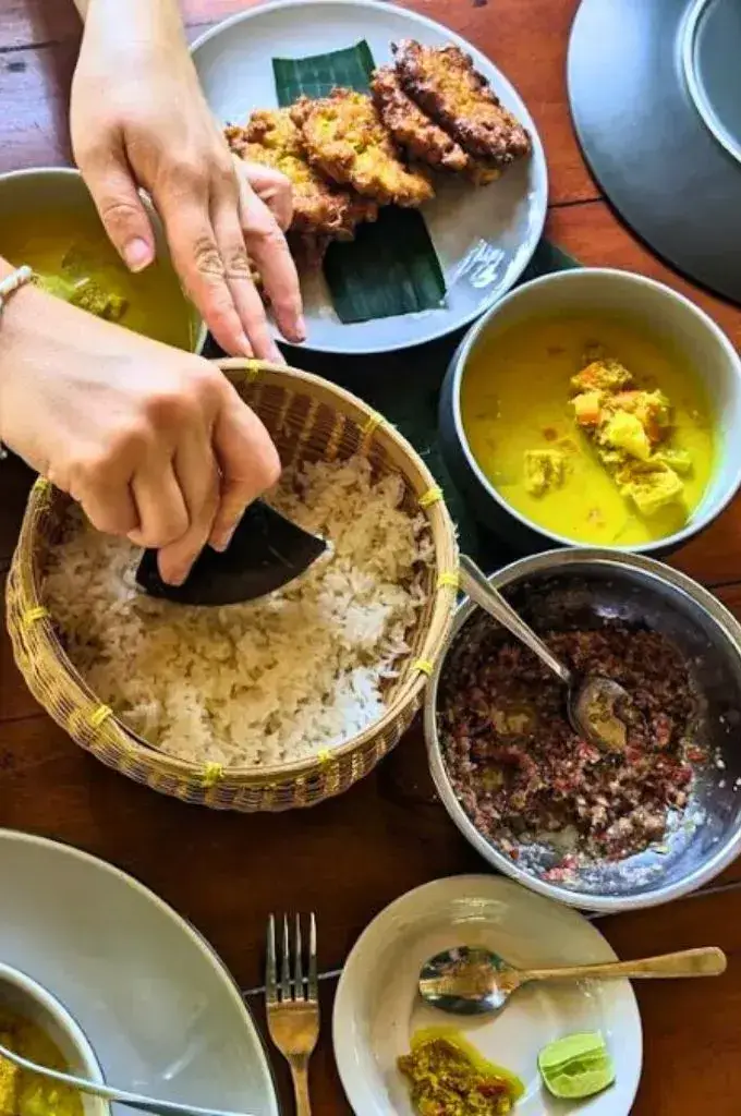 scooping the white rice and ready to eat after the cooking class in bali