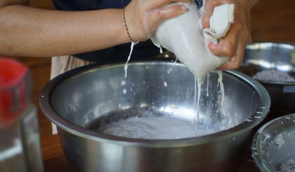 Coconut Oil Making 7 Squeezing coconut milk from grated coconut