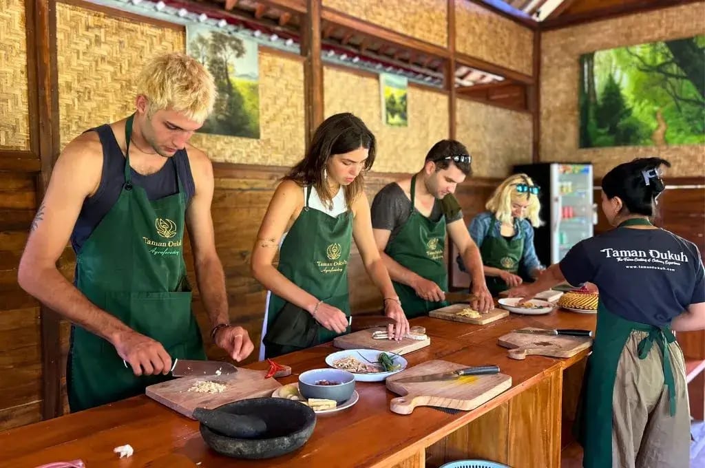 Balinese Cuisine 12 the cooking participants at taman dukuh farm are cutting the ingredients for cooking